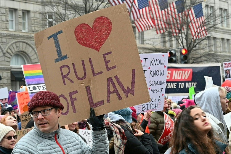 Protesters display their signs as they walk down Pennsylvania Avenue past the Trump Tower during the Women's March in Washington, D.C. January 19, 2019.